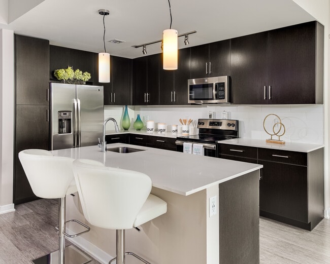 Tower Building kitchen with stainless steel appliances and kitchen island