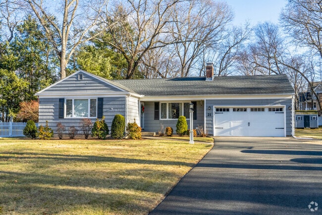 A ranch style home in East Longmeadow has an attached garage and large front yard.