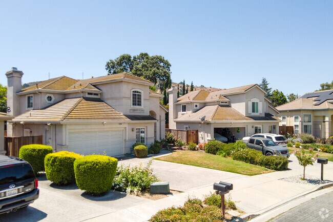 Contemporary Mediterranean-style homes in Chantillery feature tile roofs, arched windows, and tidy lawns.