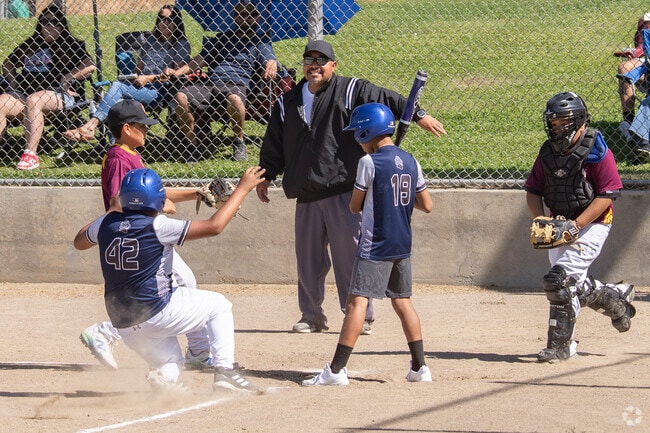 A player slides into homebase at a tournament in W.H. Shafer Park.