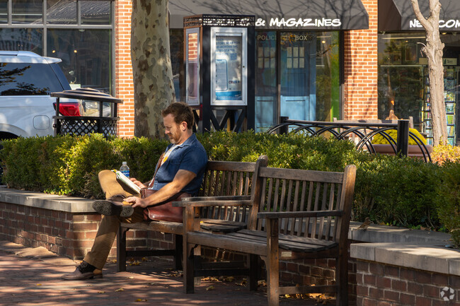 Take a break from walking and read a book near University District.