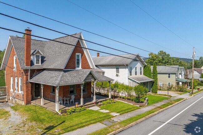 Colonial style homes have covered front porches in Milesburg in Boggs Township.