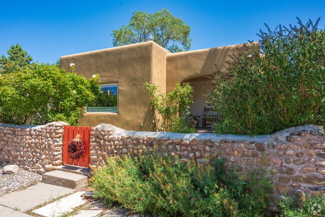A few homes in West Guadalupe Historic feature stone parapet walls around the outside.