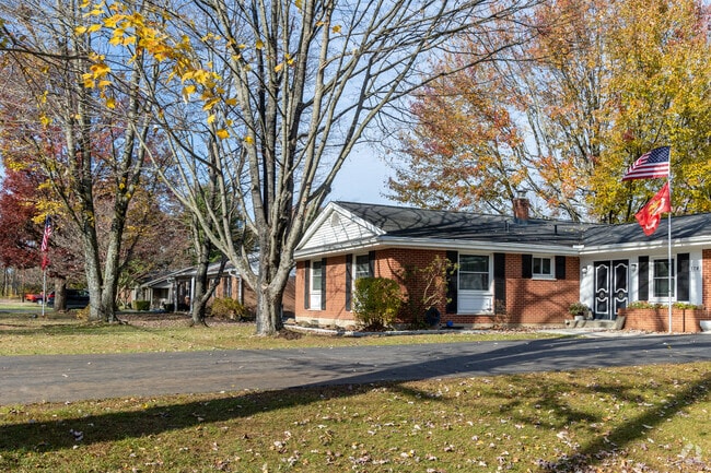 A row of single-story, well-built brick homes lines a street in Owensville.