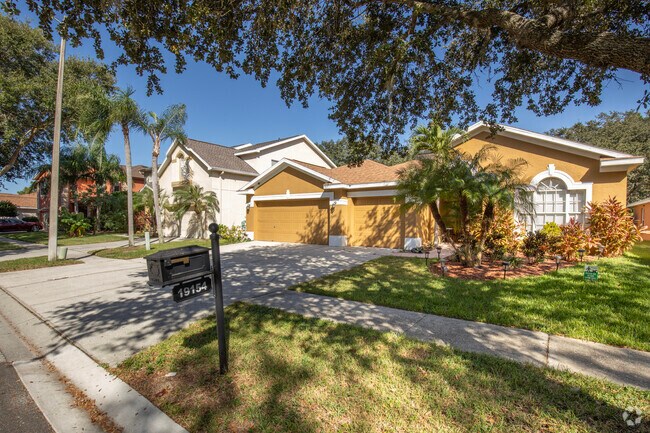 Some of the homes in West Meadows have bold colors with tropical landscaping.