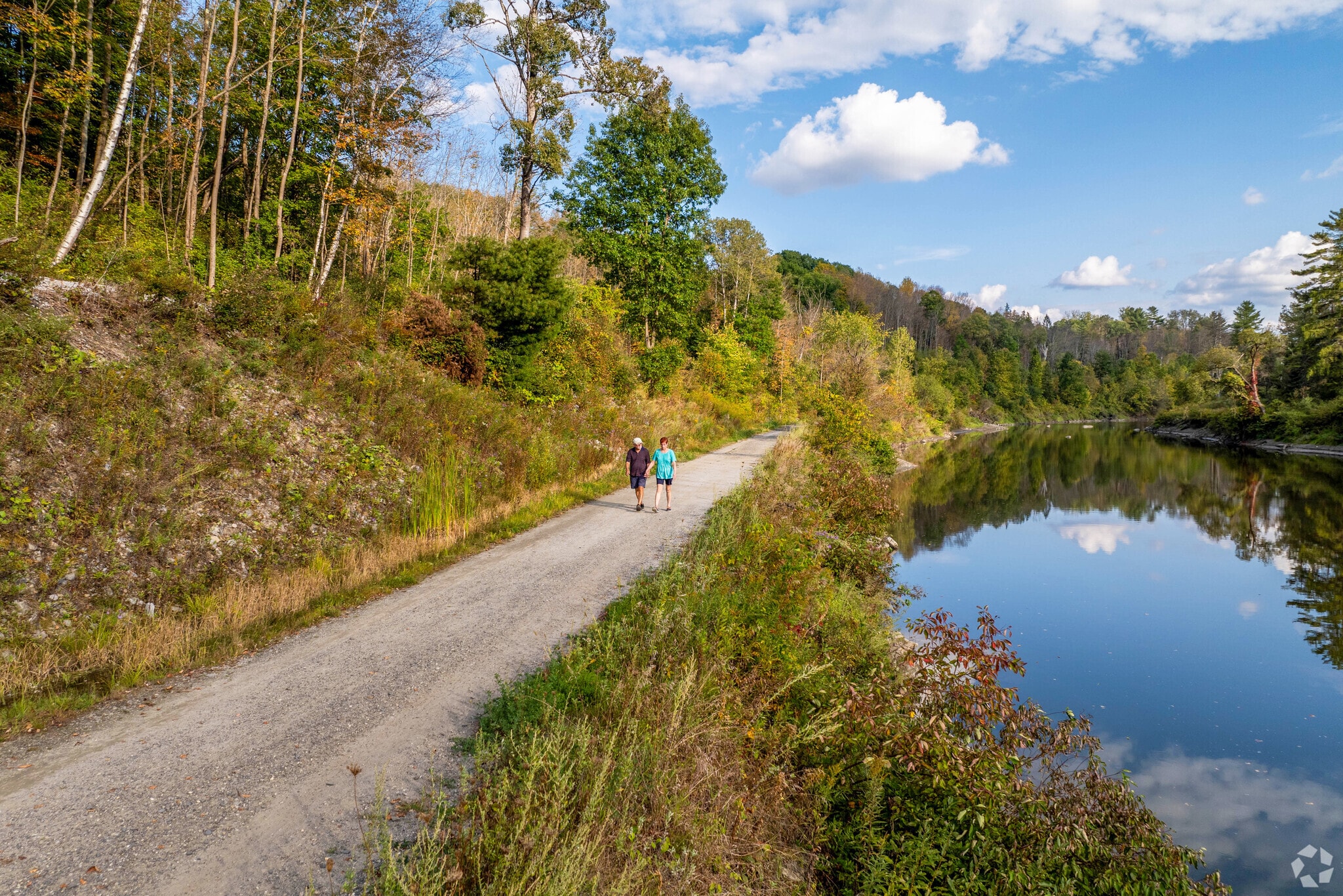 Folks walk along the Winooski River on the Montpelier VT Cross bike path near Northfield Street.