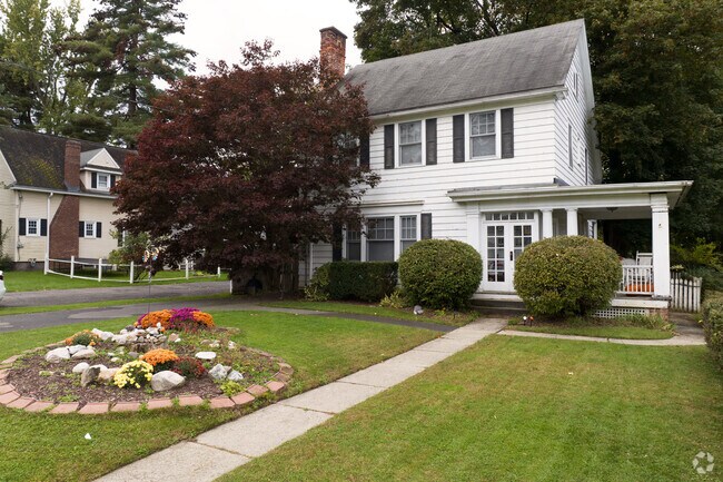 A Colonial home with a lovely side porch in Troy, NY.