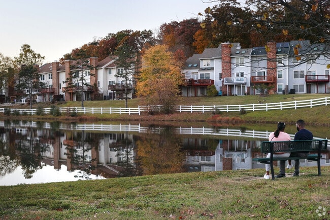 A couple relaxes and looks out over Laurel Lake.