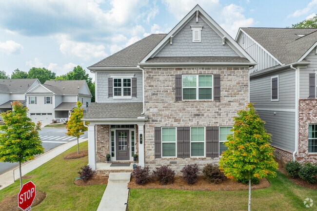 Single family homes with stone front and manicured yards showcase Whitlock's suburban charm.