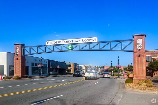 The Historic Downtown Conway arch welcomes visitors to a vibrant district filled with shops, dining, and local attractions.