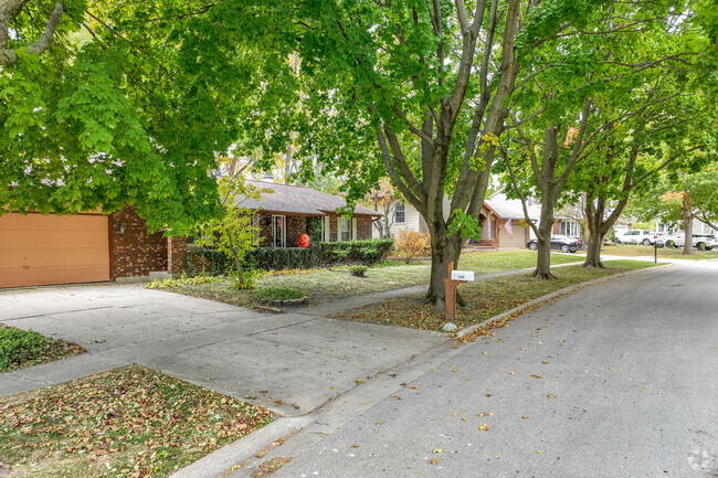 Rows of homes within Century Oaks West are covered in mature trees along the streets.