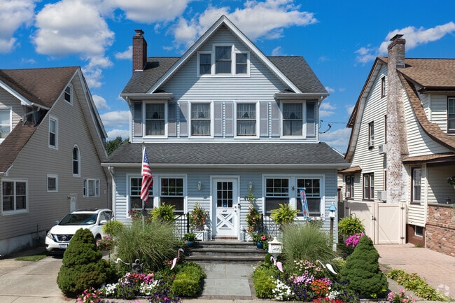 Some Bellerose Terrace homes feature colorful front yard gardens.