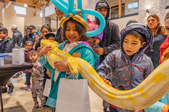 Come to the annual Spring Family Eggstravaganza and hold a large snake.