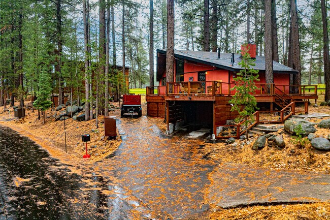 Cabins with broad decks nestle among tall pines across Joerger Ranch.