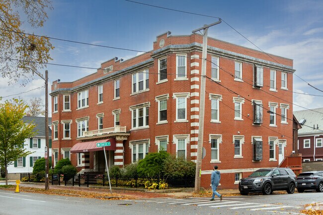 A classic early 20th-century brick apartment building stands at the corner of Chase Street in The Point, Massachusetts, showcasing the neighborhood’s historic urban architecture and timeless character.