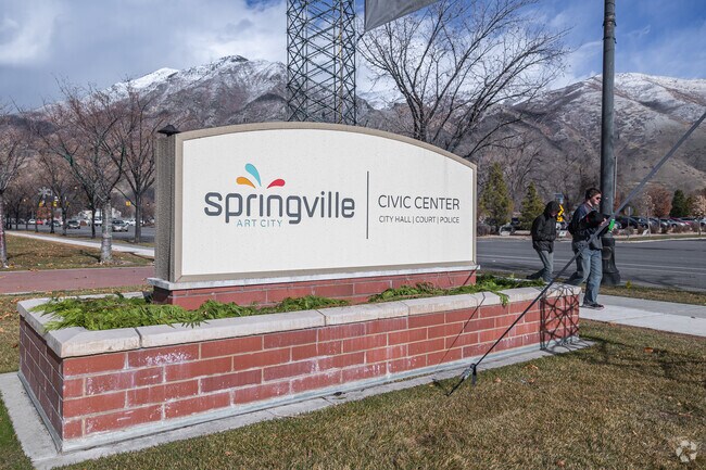 Two friends walk on the sidewalk in front of Springville Civic Center in Westfields North.