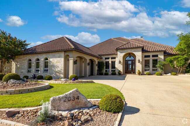 A lovely large limestone home with a stucco roof found in Kerrville.