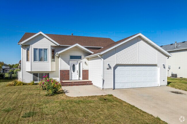This split-level contemporary home has a simple yard and 2-car garage in Willow Park.