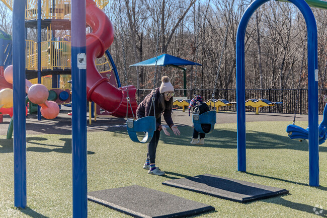 Moms enjoy with their kids in the playground in Angela's Adventure in Tolland, CT.