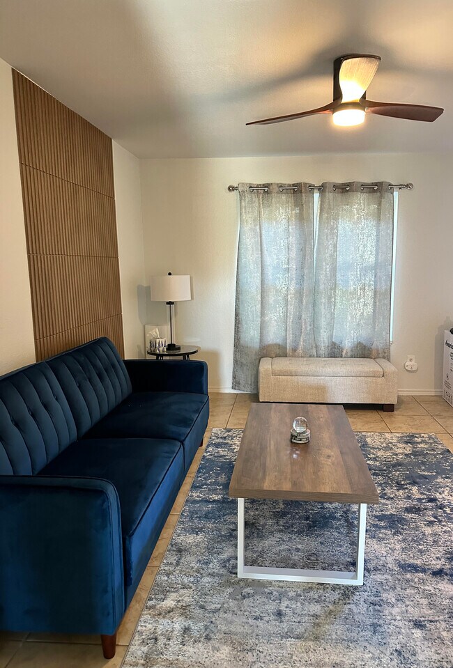 Another view of living room with new coffee table, new bench, new rug and new ceiling fan