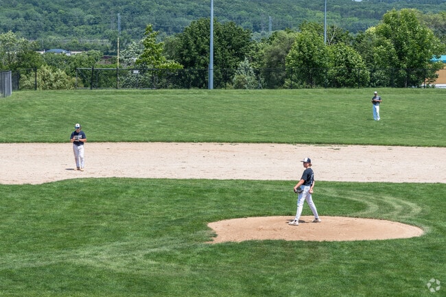 A pitcher watches the catcher's signals during a scrimmage at Lemont High School in Hastings.