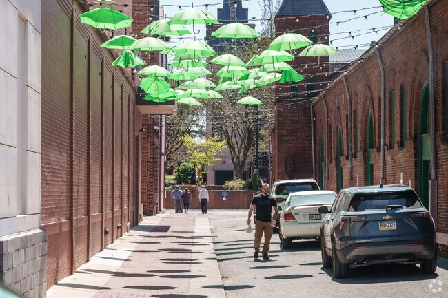 Colorful umbrellas provide shade for people at The Central Market in Northeast York.