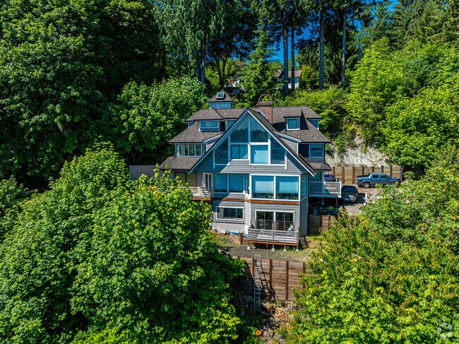A Neo-eclectic two-story style home hidden amongst the West Olympia tree's.