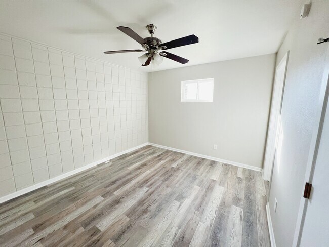Sleep soundly in this spacious bedroom with a ceiling fan.