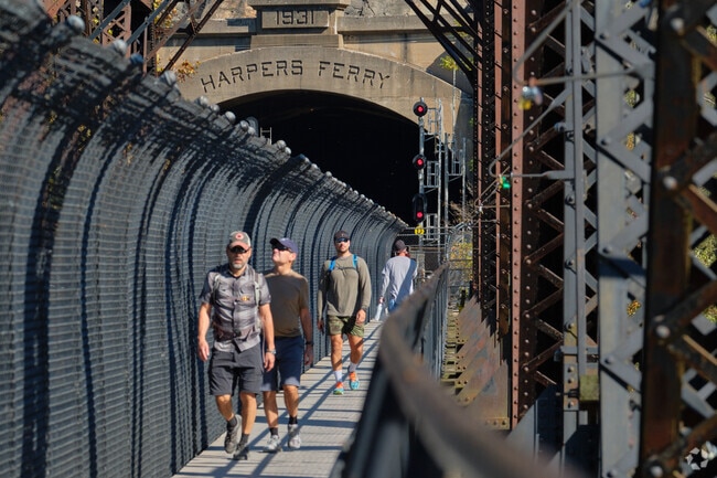 Visitors use the pedestrian footbridge to cross the Potomac River in Harpers Ferry.