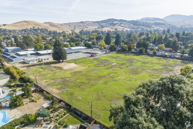 Woodside Elementary School has a large green park for play activities.
