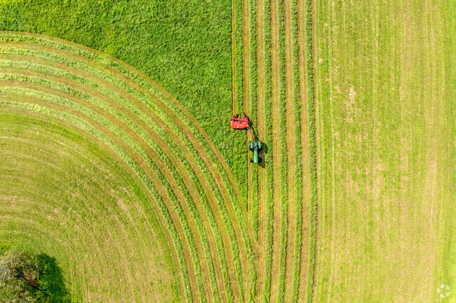 A tractor works the fields, showcasing Franklin's lush countryside charm.