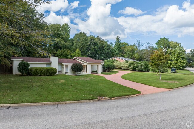 Ranch homes in Cary Woods are surrounded by tall mature shade trees.