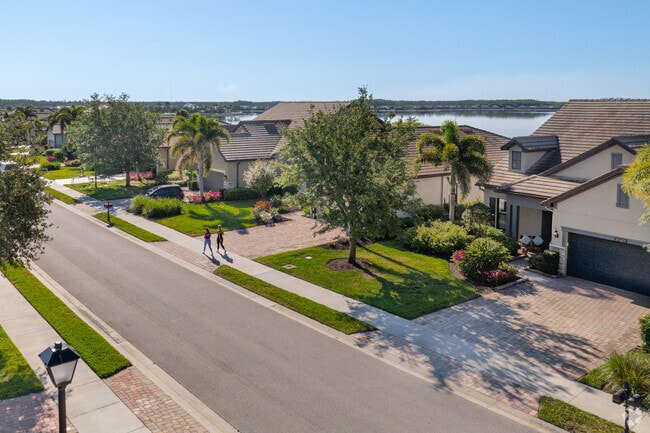 Taking a walk with a friend is a fun perk on a warm morning in Corkscrew Shores.