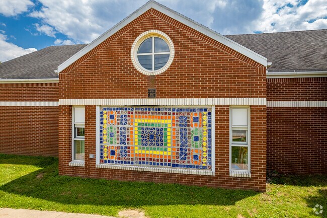 A colorful mosaic distinguishes the exterior of the Bingham Elementary School building.