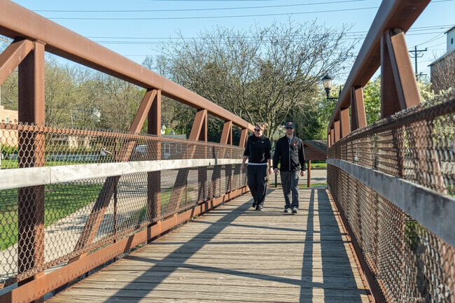 Walkers enjoy a stroll over the Fox River in Yorkville's Bicentennial Riverfront Park.