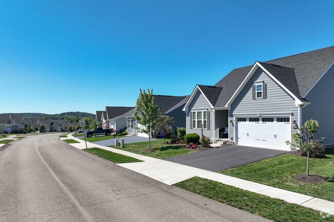 There are modern houses that are close by each other with a small yard in Middlesex Township.