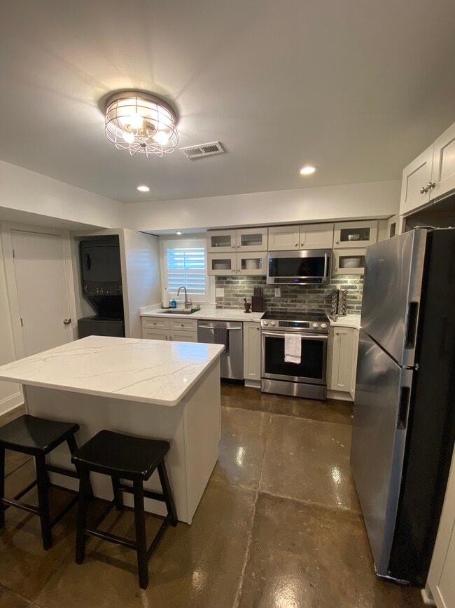 large kitchen with plenty of storage and washer/dryer included