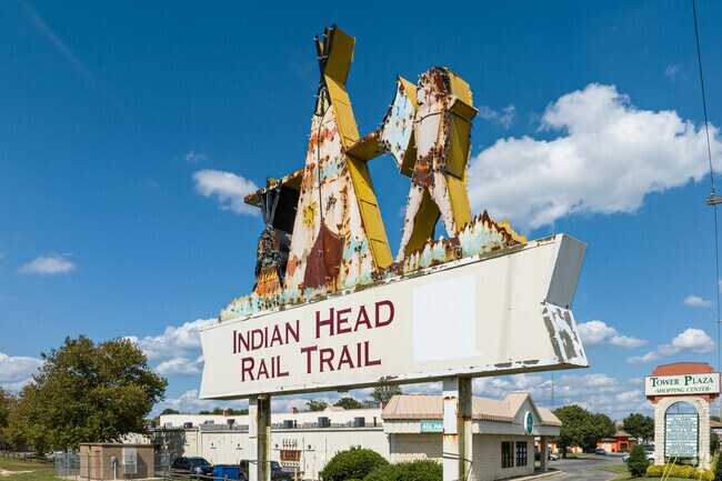 A repurposed historic sign marks the end of the Indian Head Rail Trail in White Plains.