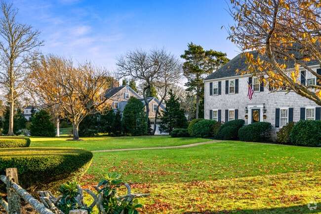 Colonial-style homes with autumn foliage line quiet Chatham streets.