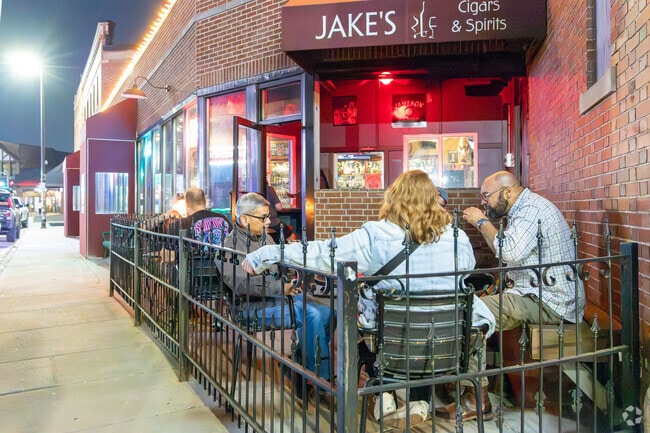 Friends enjoy an outdoor drink at Jake's Cigar & Spirits in Waverly Park.