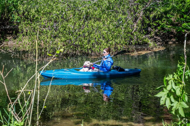 A woman takes her dog along for the ride during the 3rd Annual Tenmile Creek Regatta in Amwell Township.
