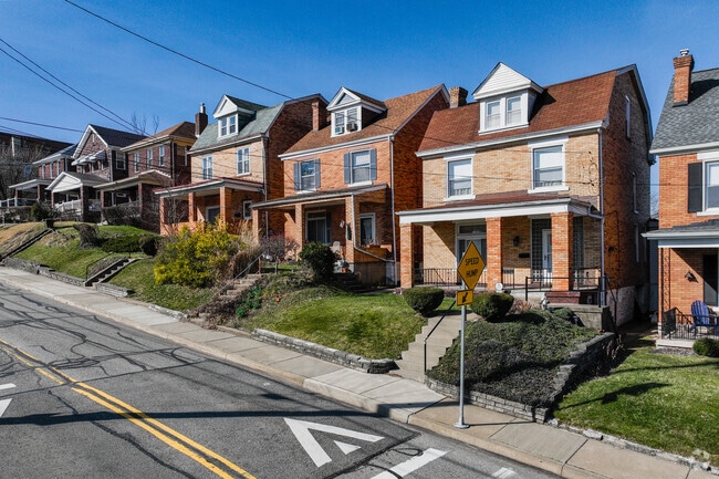 Brick Houses are lined up on a hilly road in Brookline, Pennsylvania.