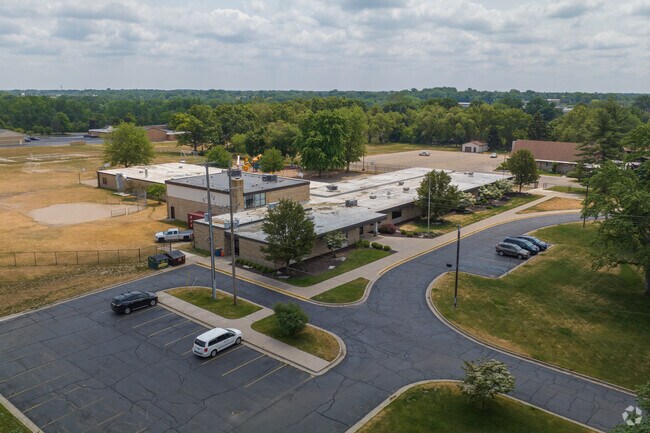 Aerial context to Plymouth Grace Christian Academy school on Ball Ave in Grand Rapids, MI.