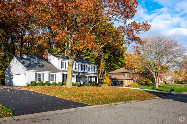 Residents of West Bloomfield enjoy large homes surrounded by dense old growth trees.