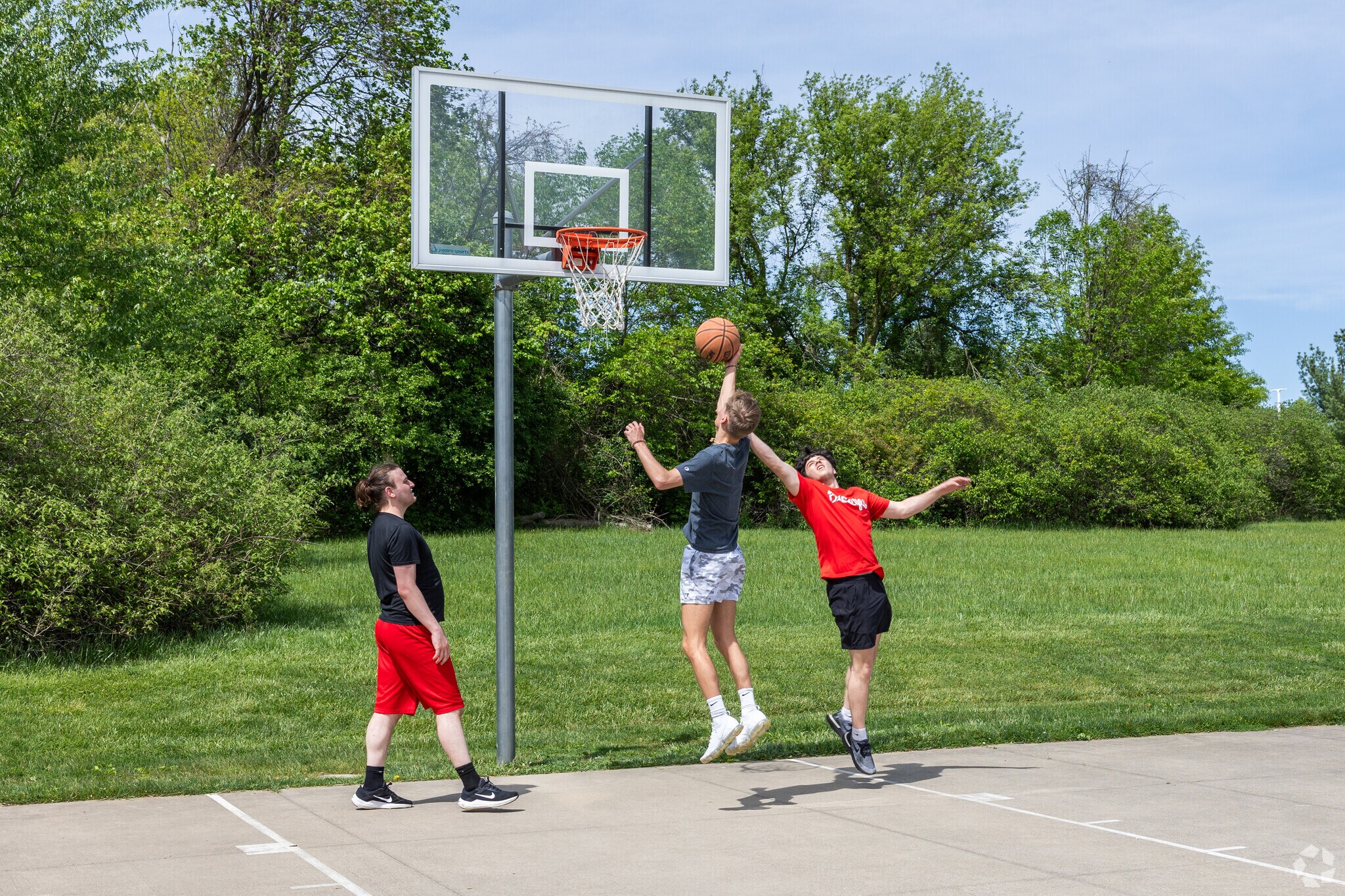 Kids play a game of basketball at Columbia Woods Park in Norton.