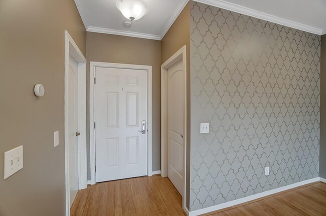 Entrance into the condo unit with the laundry room to the left and spacious coat closet to the right