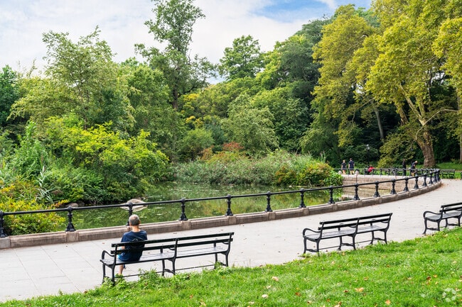 Paved walking paths lined with trees and shaded benches can be found across Prospect Park.