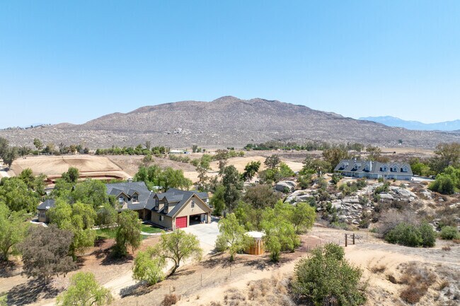 Green-covered residential area with distant mountain views.