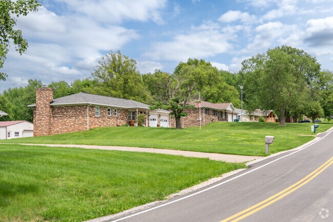 Rows of brick ranch style homes line a hilly road in Parkers Settlement.