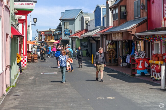 Visitors meandering along vibrant Monterey Pier near Prunedale.